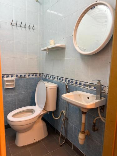a bathroom with a toilet and a sink at Heeren Street Boutique Hotel at Jonker Walk in Melaka