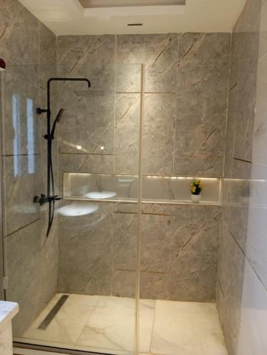 a shower with a glass door in a bathroom at Sujimoto Shortlet Ave Forche, Banana Island, Ikoyi in Ikoyi