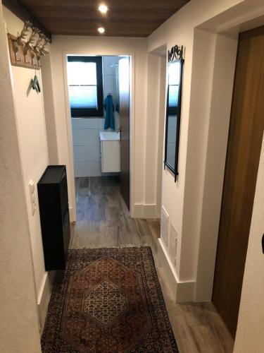 a hallway with a door and a rug at Landhaus Osttirol in Iselsberg