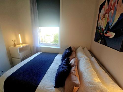 a bedroom with a bed with a couch and a window at Christchurch House in Folkestone