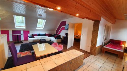 a living room with a couch and a table at Gästehäuser Schmidt Schenklengsfeld in Schenklengsfeld