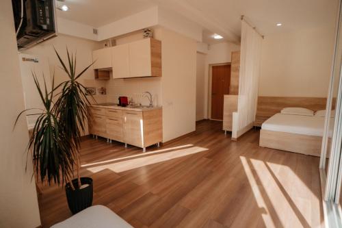 a bedroom with a bed and a sink in a room at Cathedral park studio in Chişinău