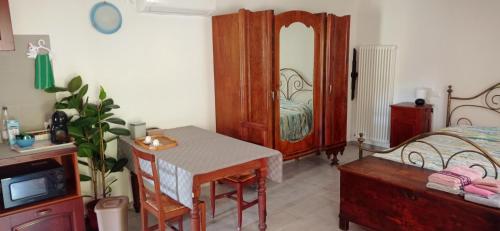a bedroom with a bed and a desk and a table at Agriturismo IL CERRO in Marzabotto