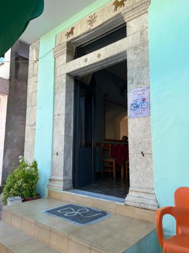 a building with an open door with a table in the background at Hotel Restorant JORGO in Leskovik