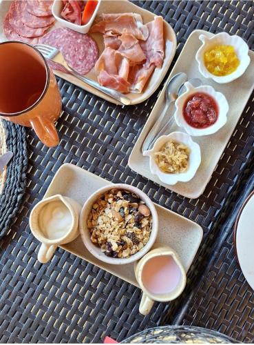 a table with a variety of food on trays at B&B Buenavista Barichara in Barichara