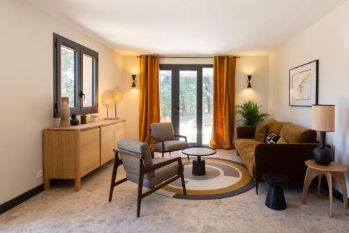 a living room with a couch and a table at Les Villas du Château de Lastours in Portel-des-Corbières