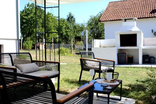 a group of benches sitting on a patio at Vila Conceptt casa in Jasenak