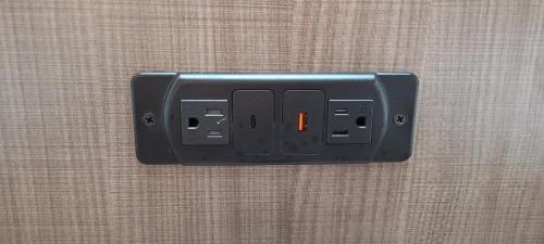 a light switch with an orange light on a wall at Red Roof Inn Charlotte - Airport in Charlotte