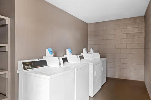 a row of white washing machines in a room at Red Roof Inn Charlotte - Airport in Charlotte
