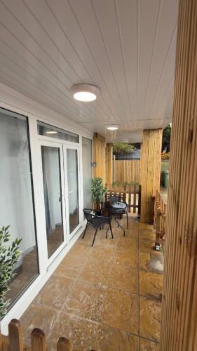 a screened in porch with a table and chairs at Bacton Coastal Retreat in Bacton