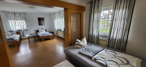 a bedroom with a bed and a desk in a room at Gästehäuser Schmidt Schenklengsfeld in Schenklengsfeld