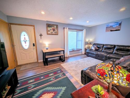 a living room with a leather couch and a table at By State Fair 5 bedrooms 2 baths in Des Moines