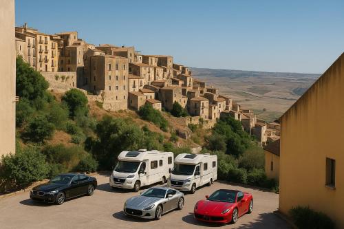 a group of cars parked in a parking lot in front of a mountain at SEGESTA Nouveau Bedding in Salemi