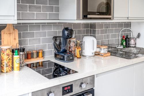a kitchen counter with a mixer on top of it at Central Harrow 5 Studio Apartment Block in Harrow