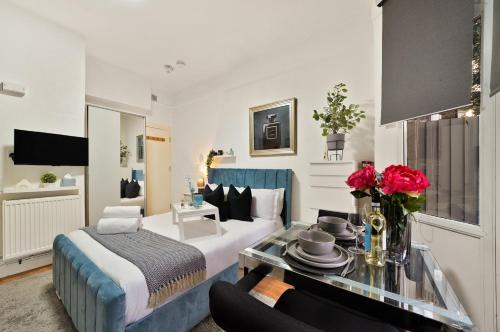 a hotel room with a bed and a table at Central Harrow 5 Studio Apartment Block in Harrow