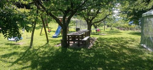 a picnic table in a park with a slide at Agriturismo IL CERRO in Marzabotto