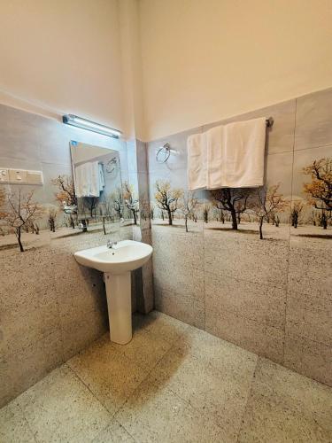 a bathroom with a sink and a mirror at Revival Beach Resort in Hikkaduwa