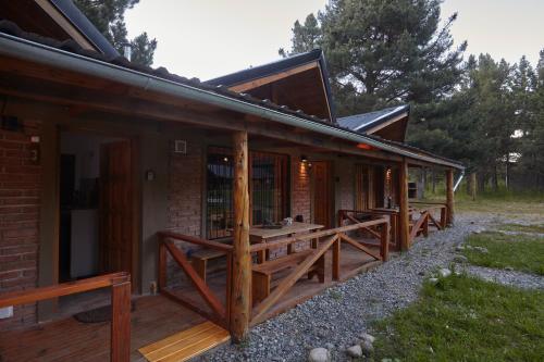 a house with wooden decks on the side of it at Brisa del Bosque in El Bolsón
