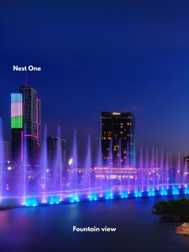 a city with fountains in the water at night at Nest One Luxe, Элитные апартаменты с балконом и видом на фонтан Tashkent City Park 077 in Tashkent