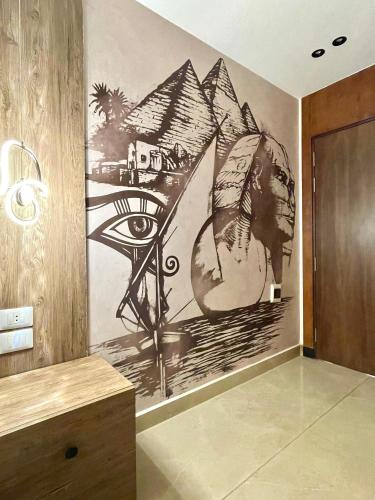 a painting of an eye on a wall in a room at City plaza pyramids view in Cairo
