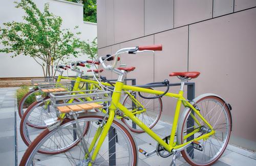 a row of yellow bikes parked next to a building at NYX Hotel Munich by Leonardo Hotels in Munich