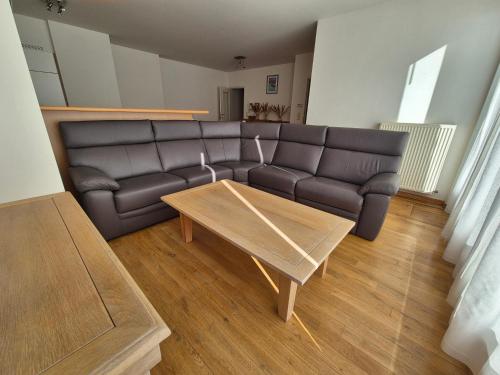 a living room with a couch and a coffee table at Appartement aan zee Blankenberge in Blankenberge