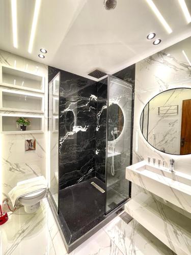 a bathroom with a shower and a sink and a mirror at City plaza pyramids view in Cairo