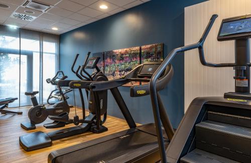a gym with two tread machines and a treadmill at NYX Hotel Munich by Leonardo Hotels in Munich