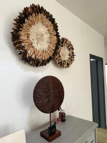 a table with two large mirrors on a wall at Atelier Industriel in Mbour
