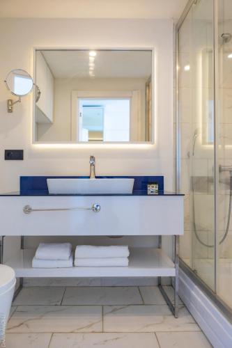 a bathroom with a sink and a mirror at Panorama Sea Side Hotel in Batumi
