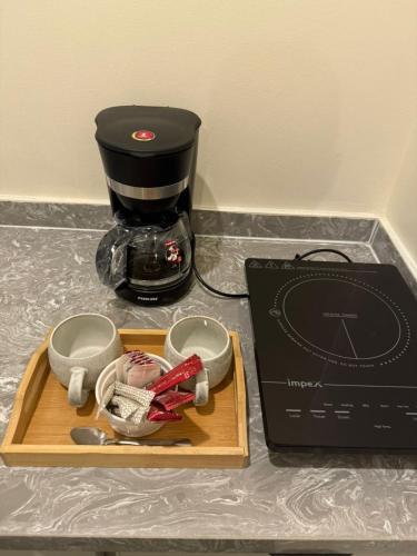 a coffee maker and a box on a counter at diva suite نزل in Hail