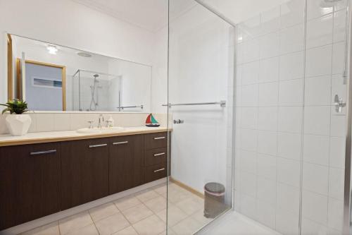 a bathroom with a glass shower and a sink at Locanda in Paynesville