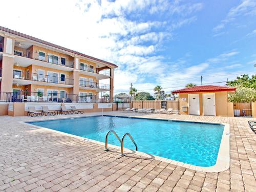 a swimming pool in front of a building at Brass Rail 311 in Tybee Island