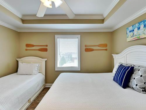 a bedroom with two beds and a window at Brass Rail 311 in Tybee Island