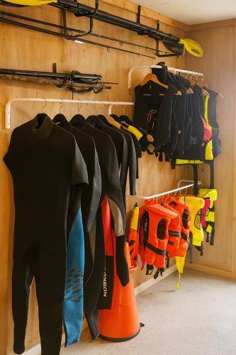 a closet with a bunch of shirts and shoes at Family-friendly Cabin with pier - Herdla to Bergen - 40 min in Herlø