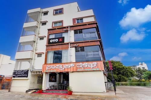 a building with an oops sign on the side of it at Hotel O SRL Comforts in Kumbalgod