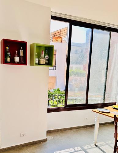 a room with a window with bottles on the wall at La Luna Luz 1BR Apt w Balcony by the Bahsa Sea in Batroûn