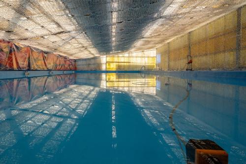 an empty swimming pool with a swimming pool at The Cabin Retreat Piešťany 