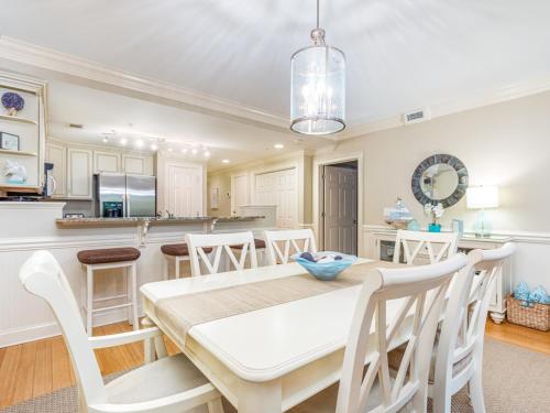 a kitchen and dining room with a table and chairs at Brass Rail 317 in Tybee Island