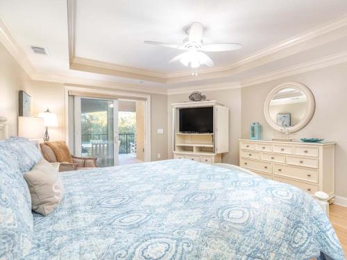 a bedroom with a large bed and a television at Brass Rail 317 in Tybee Island