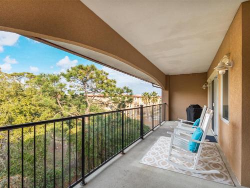 a balcony with a chair and a view at Brass Rail 317 in Tybee Island