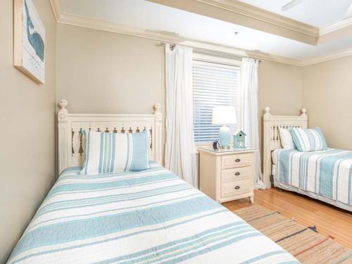 a bedroom with two beds and a window at Brass Rail 317 in Tybee Island