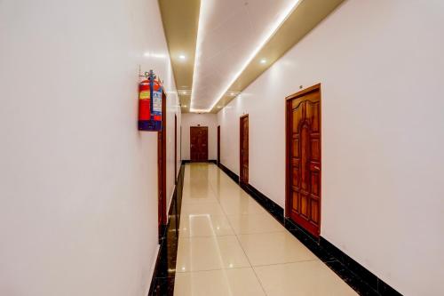 a hallway with white walls and a door at Townhouse OAK R R Palace in Varanasi
