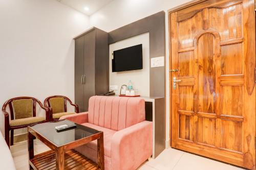 a room with a bed and a wooden door at Townhouse OAK R R Palace in Varanasi