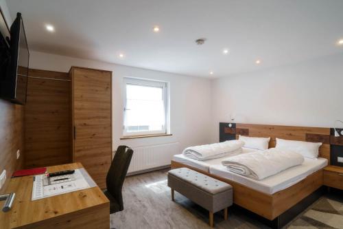 a bedroom with a bed and a desk and a table at Anita's Fewo in Ulm