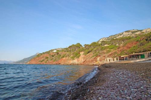 a rocky beach next to a body of water at Villa Capllonch in Banyalbufar