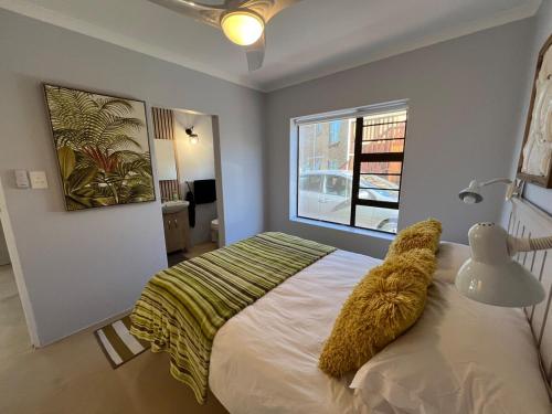 a bedroom with a large bed and a window at Seehoekie in Sedgefield
