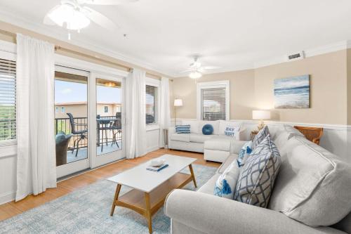 a living room with a couch and a table at Brass Rail 315 in Tybee Island