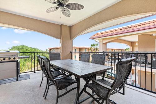 a patio with a table and chairs on a balcony at Brass Rail 315 in Tybee Island