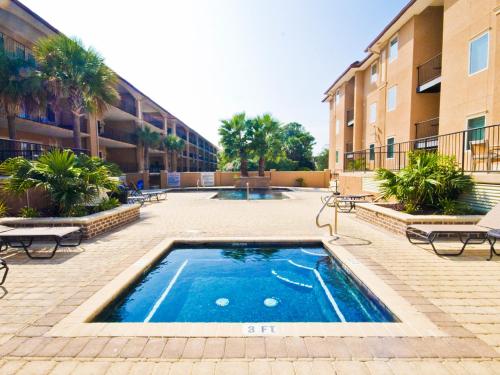 a swimming pool in the courtyard of a building at Brass Rail 303 in Tybee Island